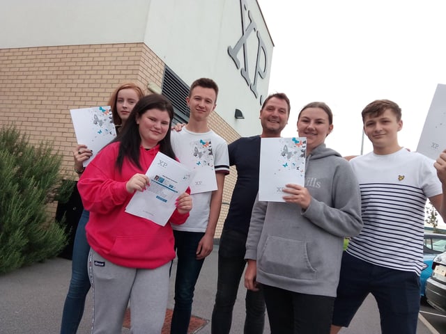 XP School principal Andy Sprakes with pupils picking up their GCSE results in Doncaster. They are the first to pass the exams at the new school