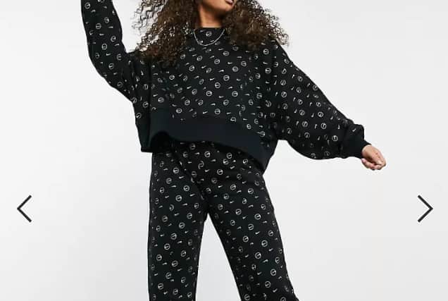 Nike all over logo print tracksuit in black. (Pic: Asos)