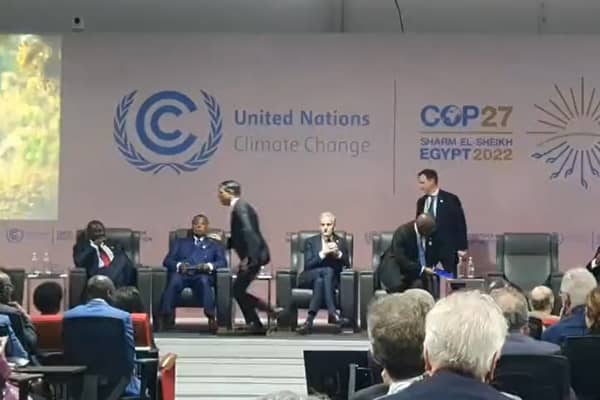 Prime Minister Rishi Sunak is seen running off the stage at an event at COP27 in Egypt.