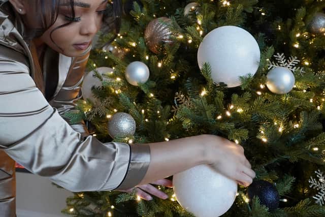 Nia Wells, 29, would hours each day wandering around looking at festive displays in shops - and wished she could make her own decorations look so perfect. The avid Christmas lover realised she could create a full-looking tree just by hanging her baubles differently.