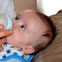 A baby drinks formula from a bottle. Pic: Pixabay.