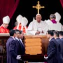 Pope Francis attends the funeral mass for Pope Emeritus Benedict XVI as pallbearers carry the coffin at the end of the funeral mass at St. Peter's square