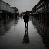 Dismal weather heralds the arrival of the UK Chancellor’s Autumn Statement as people shop in the centre of Bolton.