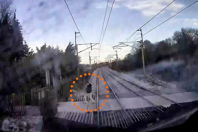 The video shows a man just inches from being hit by the speeding train.