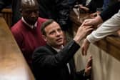 Olympic athlete Oscar Pistorius holds the hand of a relative after sentencing at the High Court on July 6, 2016 at the High Court in Pretoria, South Africa. Pistorius was sentenced to six years in prison for the murder of girlfriend Reeva Steenkamp at their home in 2013.