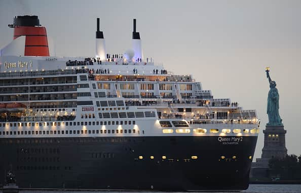 The Queen Mary 2 sails near the Statue of Liberty in New York Harbor (DON EMMERT/AFP via Getty Images)