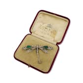 This emerald and diamond dragonfly brooch worn at three royal coronations has gone up for sale at Mayfair’s oldest family jewellers for £350,000.