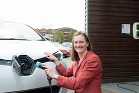 Angela Terry with EV charger to be a common sight outside all new build homes (photo: @JonCraig_Photos)