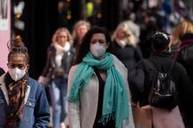 A woman wears a face mask while walking on Oxford Street durng the height of the coronavirus pandemic.