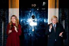 Boris Johnson (R) and his partner Carrie Symonds (L) outside 10 Downing street (Photo by Tolga Akmen / AFP) (Photo by TOLGA AKMEN/AFP via Getty Images)