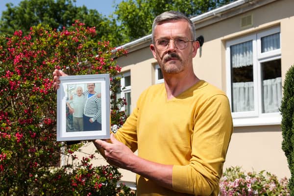 Leigh Blanning with a photo of his late father, John.