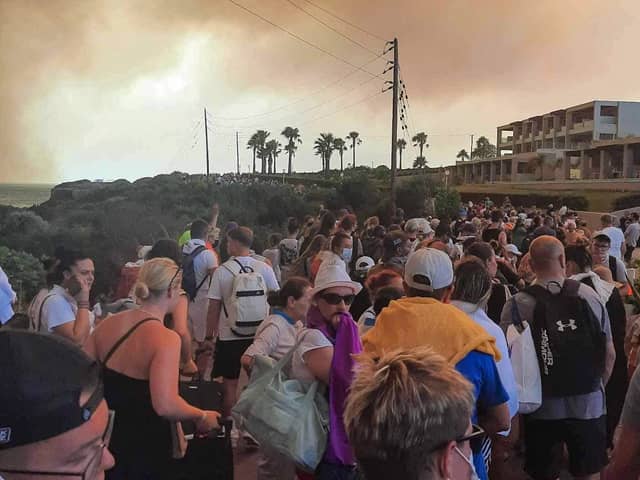 Tourists are evacuated from hotels during a wildfire on the Greek island of Rhodes on July 22, 2023.