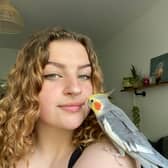 Grace Robinson, 19, with her pet cockatiel Kiki.