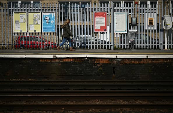 A person walks along a railway platform at Paddock Wood railway station in south east England on April 8, 2024, as train drivers strike over pay. (Photo by BEN STANSALL/AFP via Getty Images)