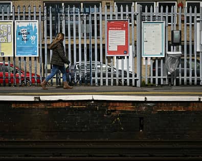 A person walks along a railway platform at Paddock Wood railway station in south east England on April 8, 2024, as train drivers strike over pay. (Photo by BEN STANSALL/AFP via Getty Images)