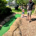 George accidentally hits his dad James between the legs at crazy golf.