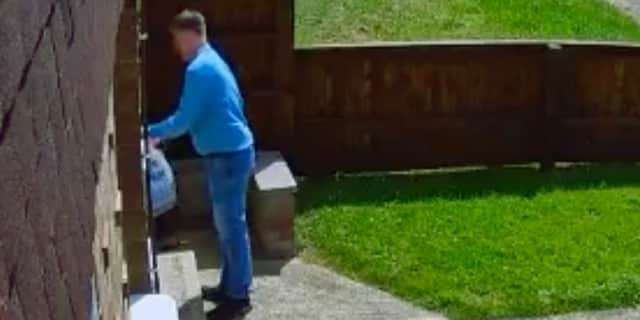 Tory canvasser removes Labour leaflet from letterbox.