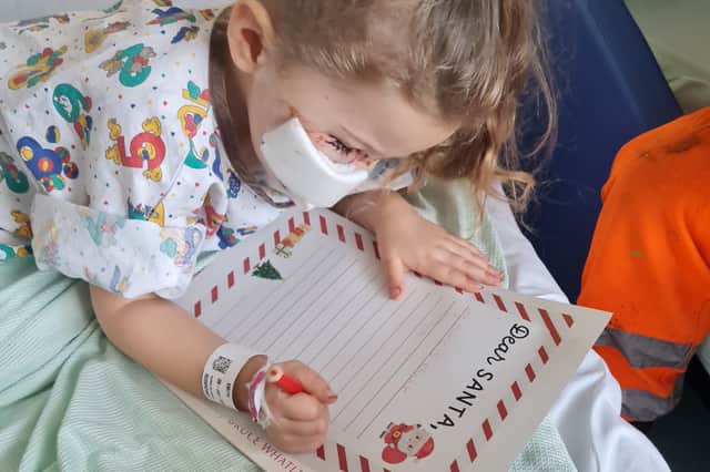 Elouise Smith writing a letter to Santa from hospital in December 2023 after the dog attack.