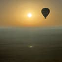 Journalist Nicola Adam journeys across the Dubai desert at dawn by hot air balloon

