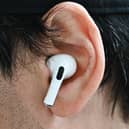 A customer wears an Apple AirPod. Photo: Patrick T. Fallon / AFP via Getty Images