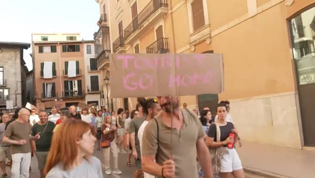 Anti-mass tourism protesters march through Palma’s streets.