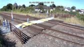 Toddler steps onto Sandy Lane level crossing in Prestatyn, North Wales.
