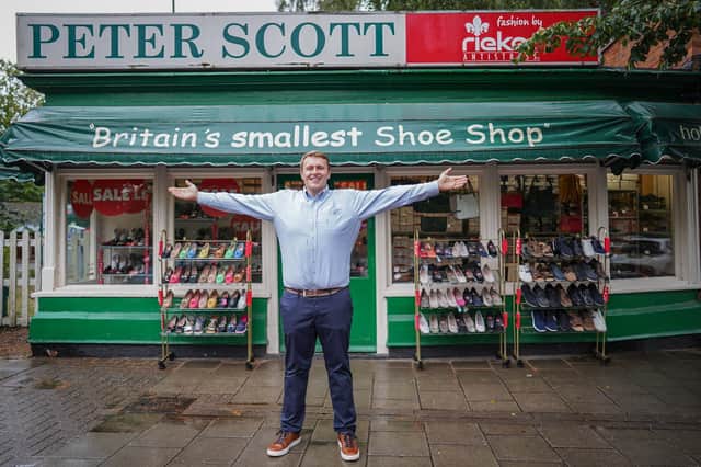 Oliver Salter, 31, who owns Peter Scott shoe shop in Woodhall Spa, Lincolnshire, Britain's smallest shoe shop.