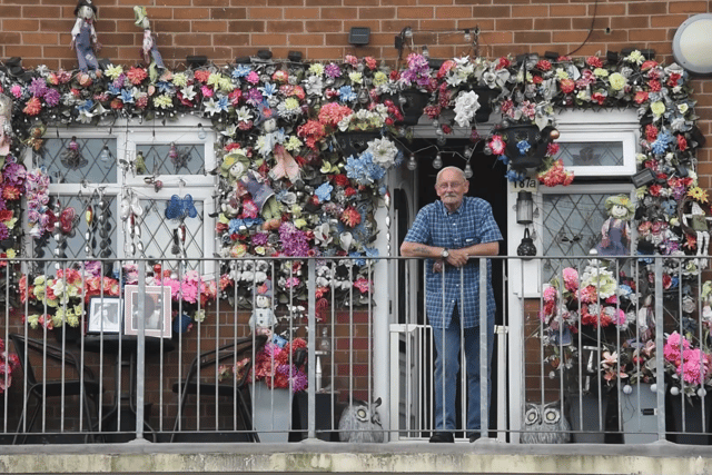 Dennis outside his colourful home in Preston
