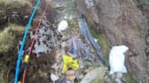 Video grab from heartbreaking footage showing 'waterfalls' of 3,000 bits of rubbish including drinks cans and Santa hats left by people on Mount Snowdon.