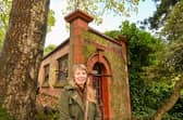 Loz Samuels pictured outside the world's smallest theatre - a former public loo in Malvern, UK.