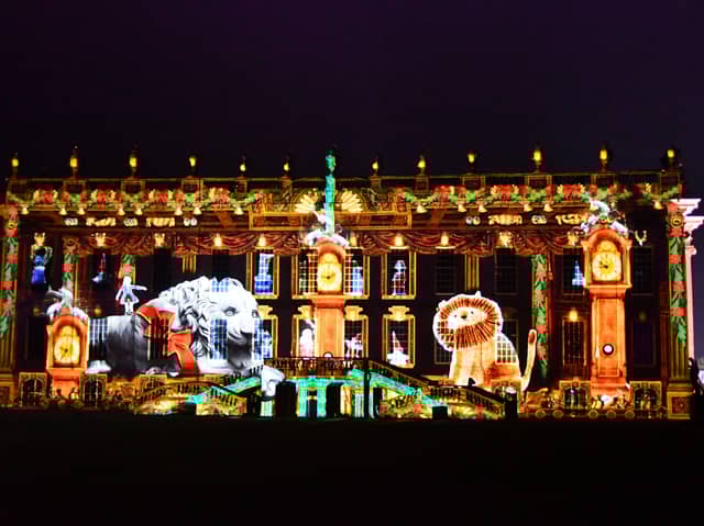 Chatsworth House is now ready and open for the public to enjoy its Christmas theme. Pictured is the front of the house with a light projection of a scene from the story Henry And The Lion's Christmas Feast.