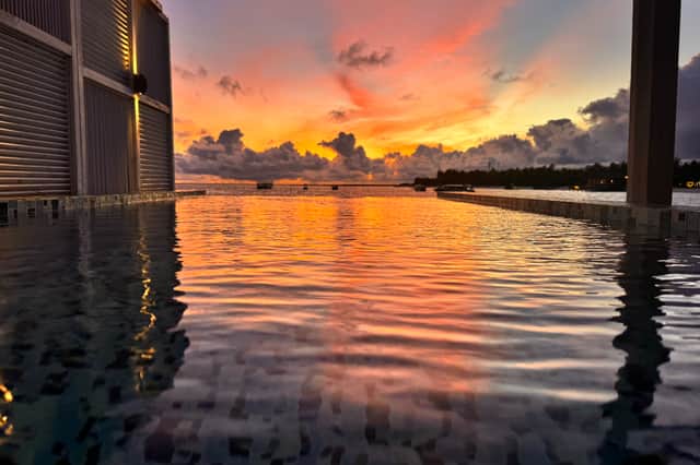 The sun sets behind my Sangeli island water villa, Maldives