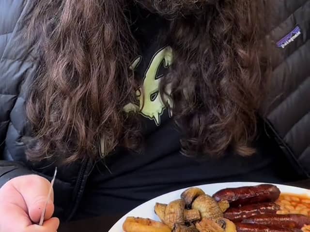 Kalani Smith reviewing a full English breakfast. British cafe goes viral after US TikToker gives glowing reviews of a full English breakfast.