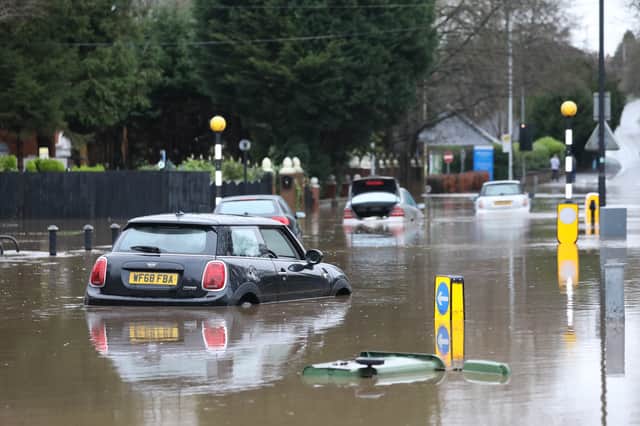 Cars stranded in deep water due to flooding in Stockport.