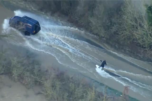 Man wakeboards along flood road in Leicestershire.