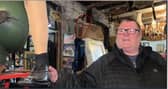Shop owner holding an artificial leg