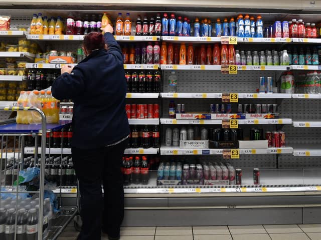 An employee stocks shelves at a Tesco supermarket in central London in 2021 (Photo: JUSTIN TALLIS/AFP via Getty Images)