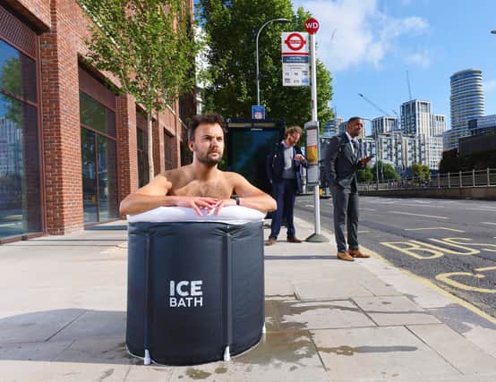 A commuter takes an ice bath at a London bus stop