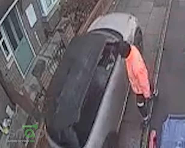 Car drives along pavement to get past bin lorry.