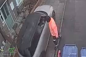Car drives along pavement to get past bin lorry.