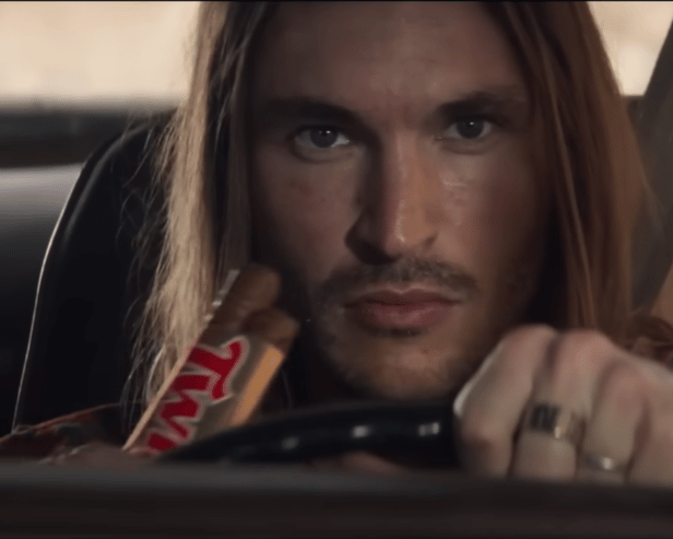A television advert for Twix biscuits has been banned by the ASA for promoting "dangerous" and "irresponsible" driving