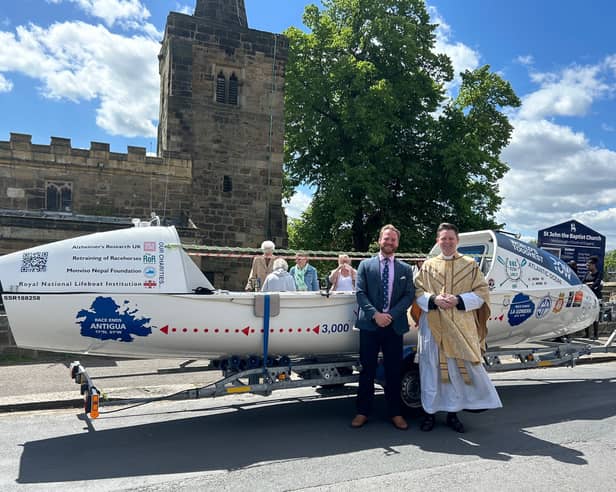 Louis and Father Edward at the boat blessing.