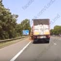 This is the moment a lorry spilled a "rotten, stinking" load of brown waste onto the A1(M) motorway in South Yorkshire, closing the highway for over eight hours.