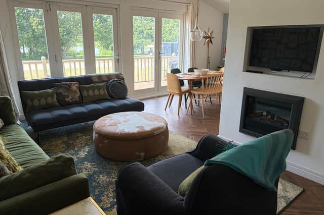 The stylish Woodpecker Lodge at Brook Meadow combines contemporary comfort with nature-inspired interiors, offering a spacious retreat overlooking the peaceful lakeside setting.