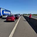 The M18 motorway is "at a standstill" in both directions close to the junction with the M62 after a car reportedly rolled over.