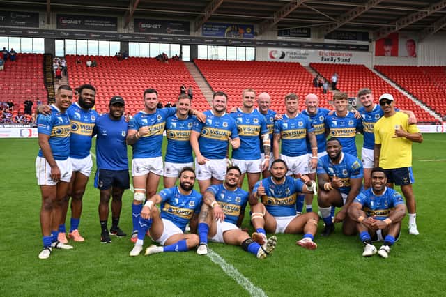 The Dons' players celebrate their momentous feat
