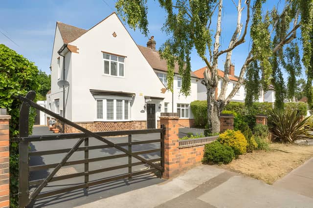 A sweeping driveway provides ample off-road parking and leads to the detached garage