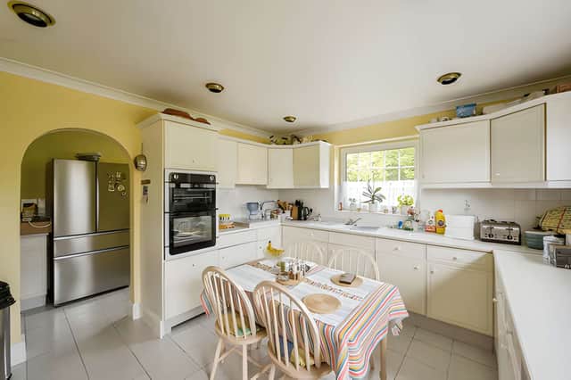 The kitchen connects to a useful utility area,