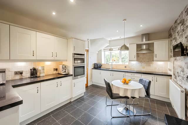 The modern fitted kitchen combines practical family living with a clean, contemporary feel