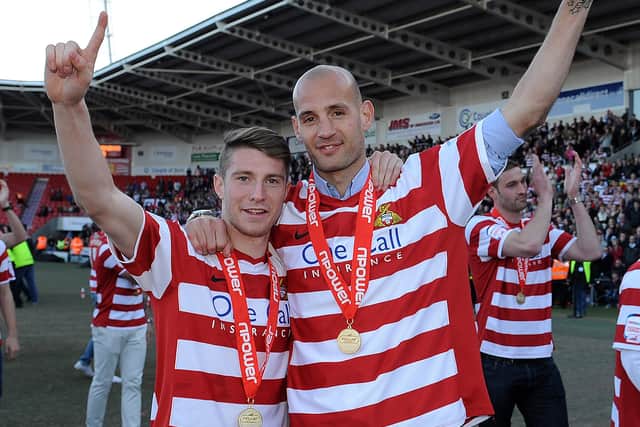 Doncaster Rovers stars James Husband and Rob Jones celebrate the presentation of the League One Trophy in 2013. Picture: Andrew Roe